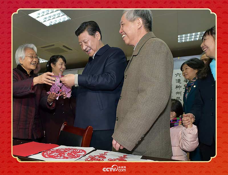 2015年2月15日，習(xí)近平在西安市雁塔區(qū)電子城街道二〇五所社區(qū)服務(wù)中心欣賞社區(qū)居民的剪紙作品。